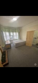 Spacious bedroom with a bright bay window...