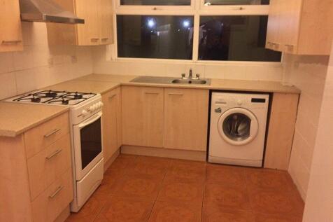 Fitted kitchen with light wood cabinets, freest...