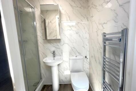 Modern bathroom with a walk-in shower, pedestal...