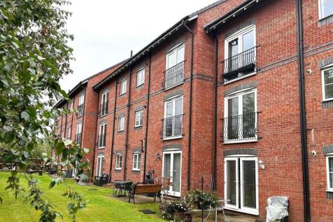 Well-maintained communal lawn and patio area be...