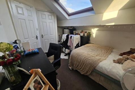 Cozy double attic bedroom with a double bed, sk...