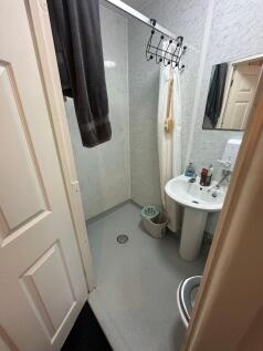 Bright bathroom with marble effect wall panels...