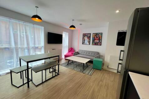 Bright, modern open-plan living area with large...