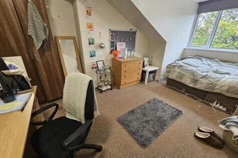 A well-kept bedroom featuring natural light fro...