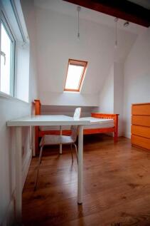 Bright attic single bedroom with desk and stora...