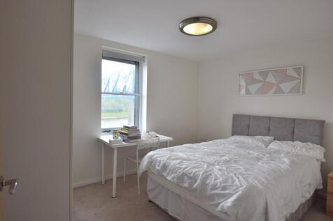 A bright and tidy double bedroom featuring a co...