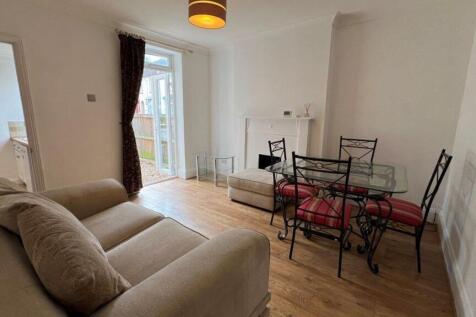 Spacious living area with comfy sofa and dining...