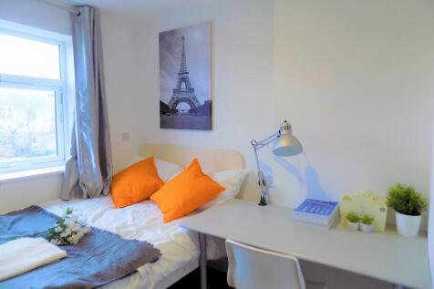 Bright and cozy single bedroom featuring a comf...