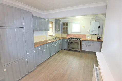 Spacious modern kitchen with ample storage spac...