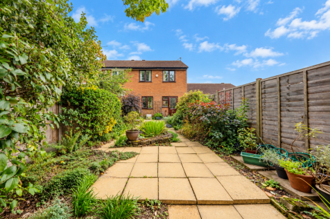 Sunlit Garden Path to Brick House