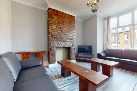 Bright and spacious living room with large wind...