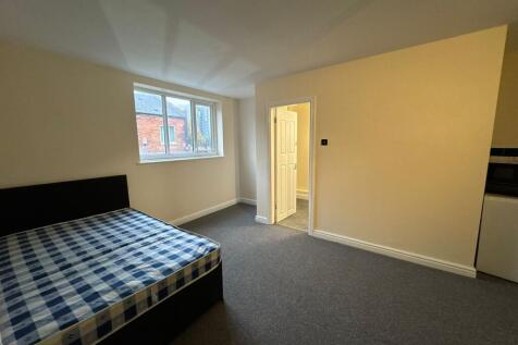A cozy bedroom with a large window providing na...