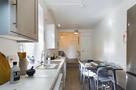 Modern kitchen space featuring sleek cabinetry,...