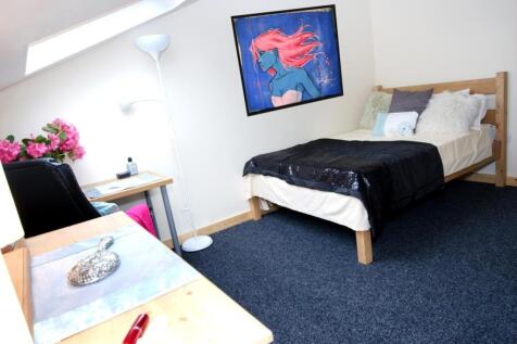 Bright, neatly styled single bedroom with a woo...