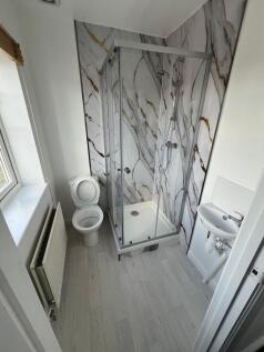 Bright and clean bathroom featuring a modern gl...