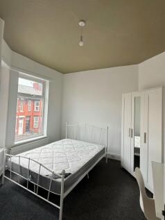 Bright bedroom with double bed and large window...
