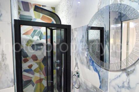Modern bathroom with a framed glass shower encl...