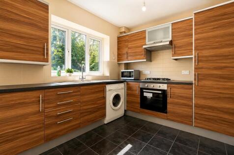 Modern kitchen with ample storage and appliance...