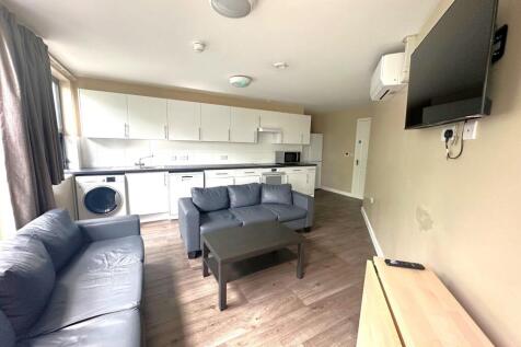 Bright open-plan living area with a fitted kitc...