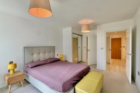 Spacious modern bedroom with comfortable bed...
