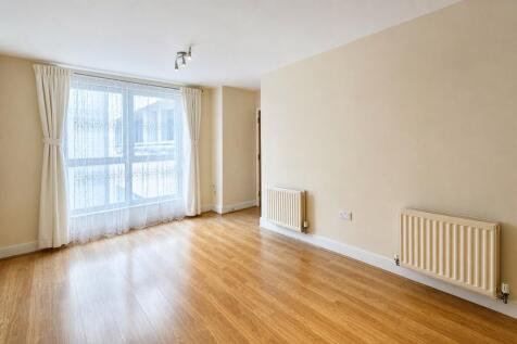 Bright and spacious living room with large wind...