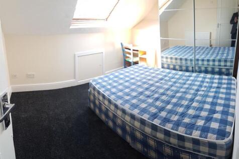 Bright bedroom with double bed and desk area...