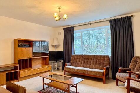 Bright, well-maintained living room with large ...
