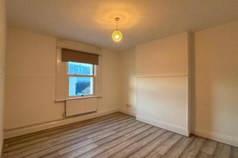 Bright, clean bedroom with modern wood flooring...