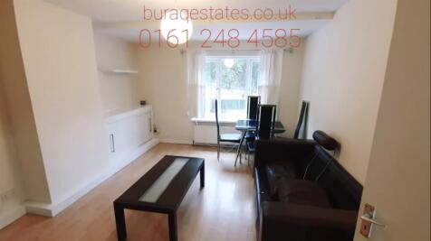 Bright, tidy living room with a large front win...