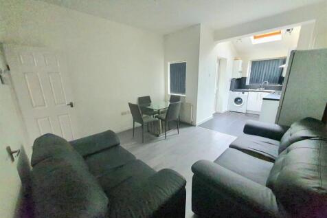 Spacious open-plan lounge with plush sofas and ...