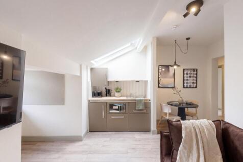 Modern open plan kitchen with skylight and dini...