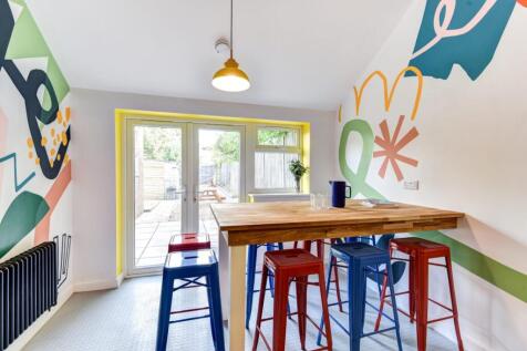 Bright, modern kitchenette/dining area with a c...