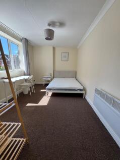 Bright, spacious room with a dedicated workspac...