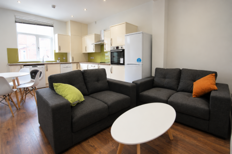 Modern Charcoal Sofas and Lime-Accent Kitchen
