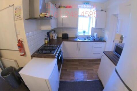 Bright, modern kitchen with white cabinets, int...