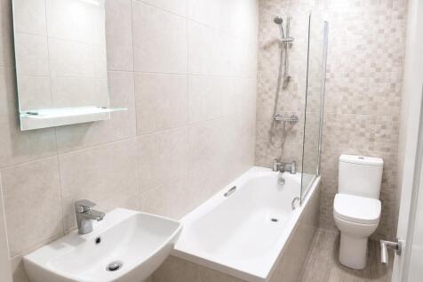 Modern bathroom suite with a sleek bathtub...