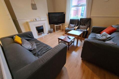 A spacious and well-lit contemporary living roo...