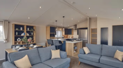 Open Plan Lounge With Blue Sofas, Dining Area And 