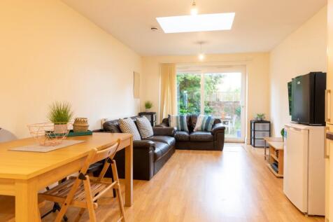 This spacious living room features a comfortabl...