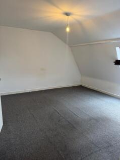 Bright, top-floor bedroom with angled ceilings,...