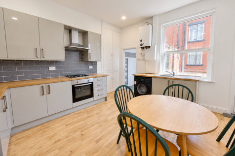 Modern Kitchen with Green Dining Chairs