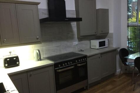 Modern fitted kitchen with neutral cabinetry, i...