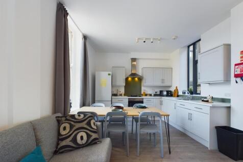 A bright and modern kitchen with ample space fo...