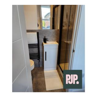 A modern and tidy bathroom featuring a sleek sh...