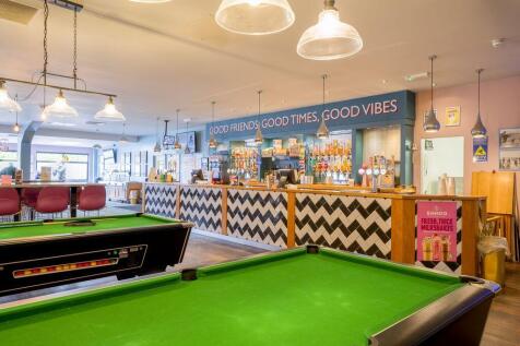 Bar area with pool tables and drinks counter at Bi