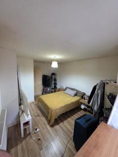 Bright double bedroom with wooden flooring, cen...