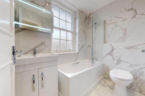 Modern marble-effect bathroom with luxury bath...