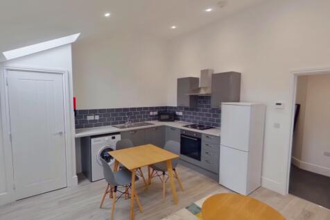 A modern and inviting kitchenette with ample na...