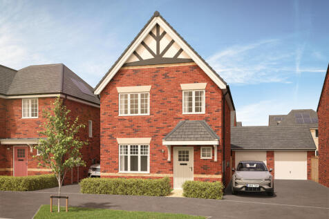A modern red brick house with a pitched roof and white-trimmed windows stands in the foreground