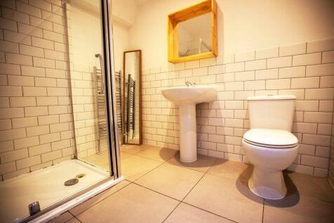 Bright modern bathroom with tiled shower...